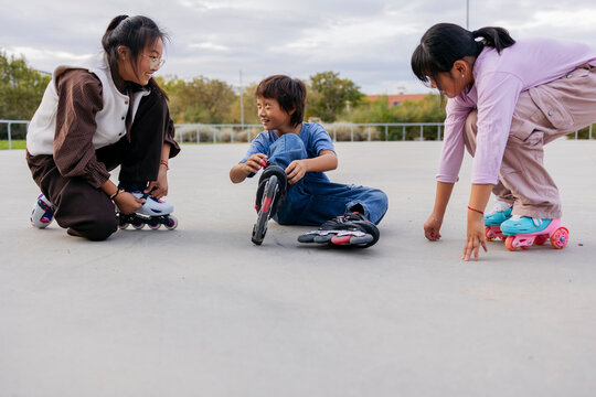 Friends preparing for roller skating in the park