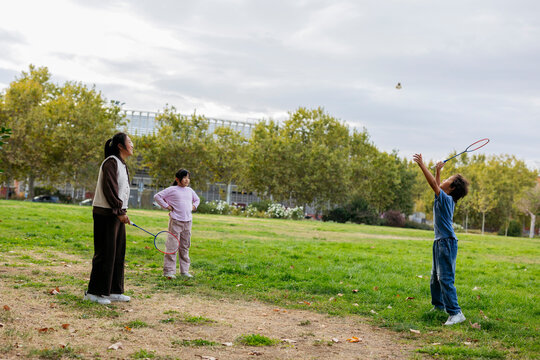 Children playing badminton in the park