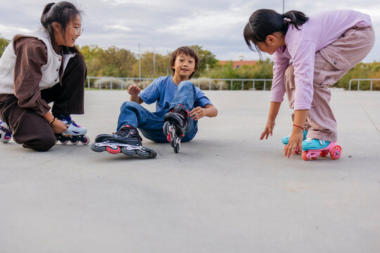 Friends preparing for roller skating in the park