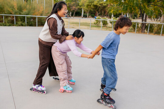 Friends roller skating together in a park