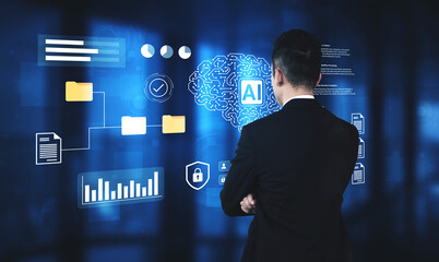 A business professional stands in a modern office, analyzing artificial intelligence data visualizations on a digital interface, showcasing innovation and strategy in technology. Gantry © InfiniteFlow