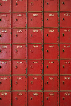 Vintage red post office boxes in orderly rows