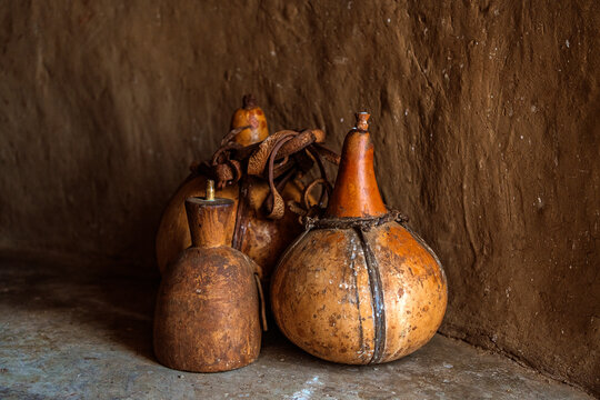Traditional African calabash containers on rustic floor