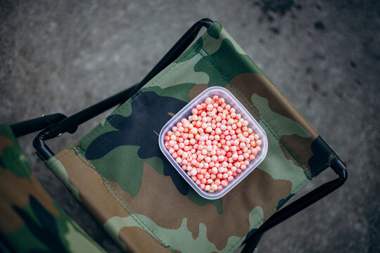 Fishing bait on camouflage fabric outdoor setup