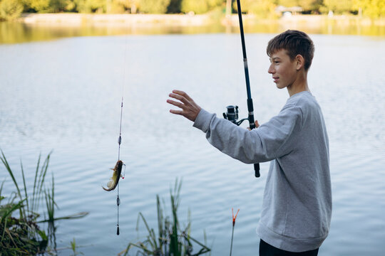 Teenage boy enjoying a relaxing fishing session by a lake