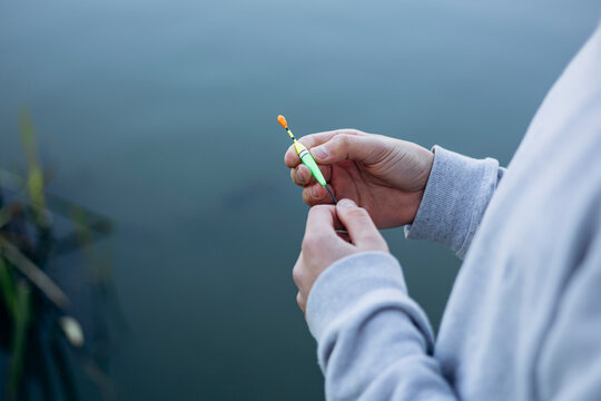 Teenage boy enjoys a peaceful fishing day by the lake