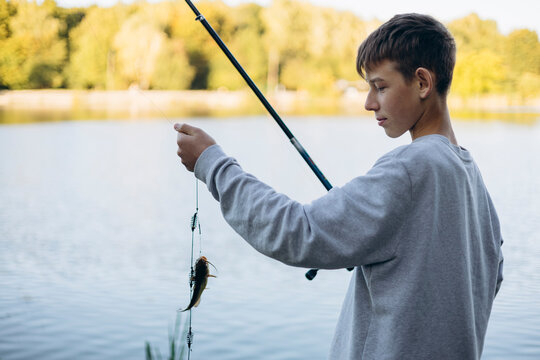Teenage boy enjoying a peaceful fishing activity outdoors
