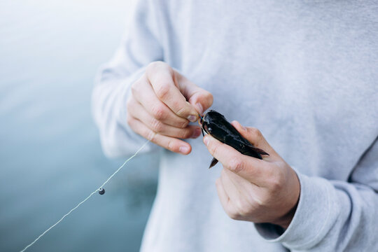 Teenage boy enjoys a serene fishing activity at lakeside