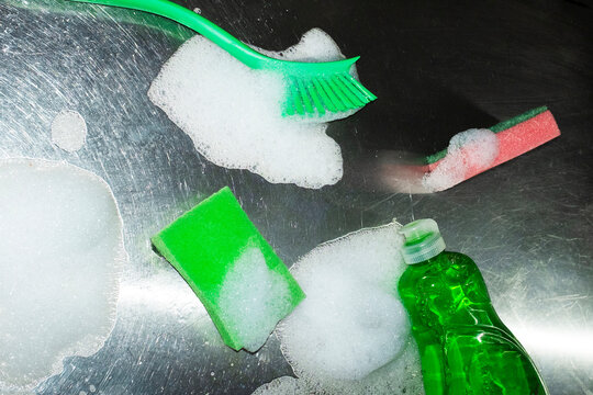 Cleaning tools with soap and foam on metal surface