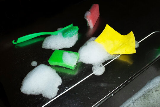 Cleaning supplies with sponges and soap foam