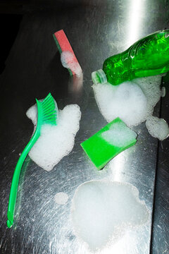 Cleaning tools with soap and foam on a metal surface