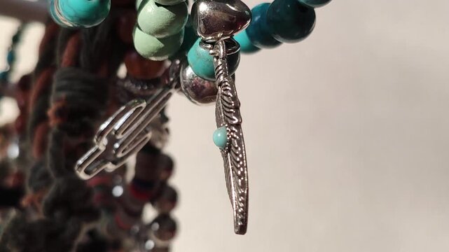 Bright wooden bead bracelets displayed on jewelry storage. Natural light enhances the colorful accessory collection.