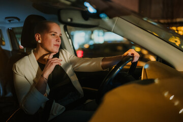 Young woman driving car at night, commuting in urban city, feeling contemplative and independent