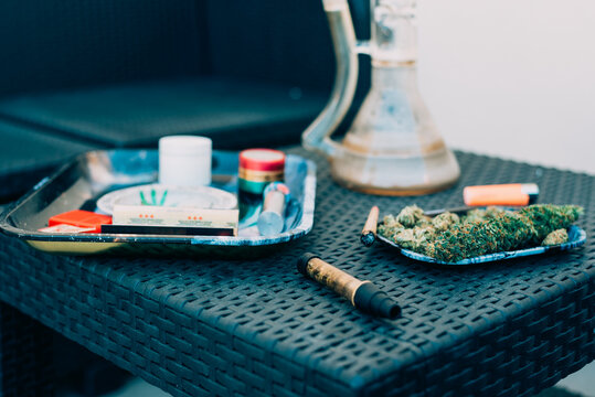 Cannabis joint and accessories on a wicker table