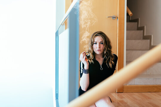 Woman enjoying a cannabis joint indoors