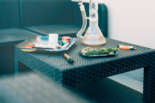 Cannabis joint and accessories on a wicker table