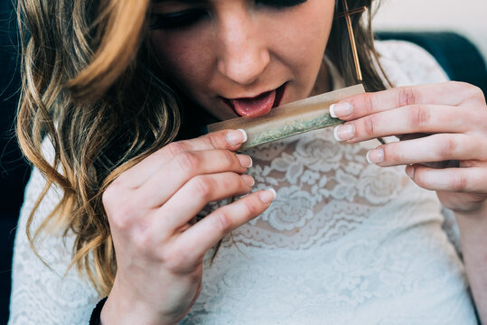 Woman rolling a marijuana joint with care