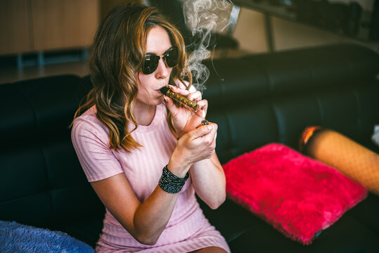 Woman enjoying cannabis with a glass blunt