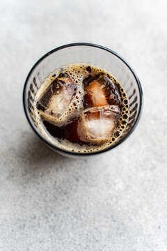 Refreshing cold beverage with ice cubes in a glass