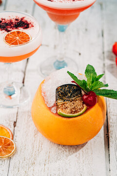 Exotic cocktail served creatively in a fresh fruit bowl