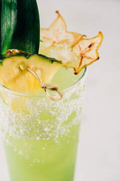 Refreshing tropical cocktail with pineapple garnish