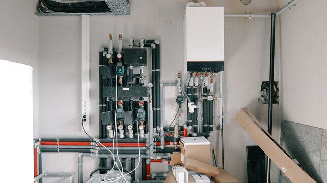 Modern heating system with boiler and complex pipe network installation