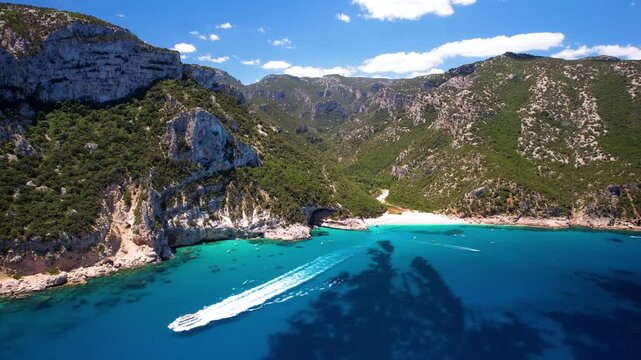 Cala Mariolu Sardinia Aerial Fast Flight. Speedboat with White Wake on Turquoise Sea. Orosei Gulf Italy. Cinematic Drone Dive to White Beach Limestone Caves 4K Mediterranean Aesthetics luxury travel