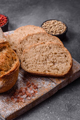 Naklejka premium A loaf of homemade whole grain rye bread for the dinner table. A loaf of rye bread