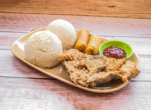 Fried bangus with rice and lumpia meal Filipino Milkfish Meal With Spring Rolls