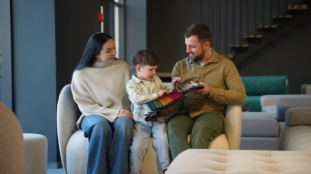 Young family choosing fabric color for new sofa