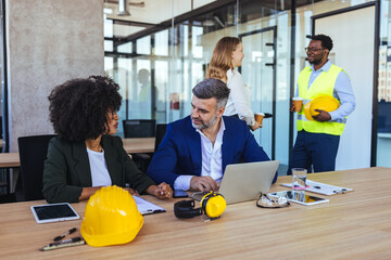Office Meeting Between Business Professionals And Construction Team Discussing Project Plans