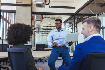 Business Presentation In Modern Office During Team Meeting Led By Manager With Laptop