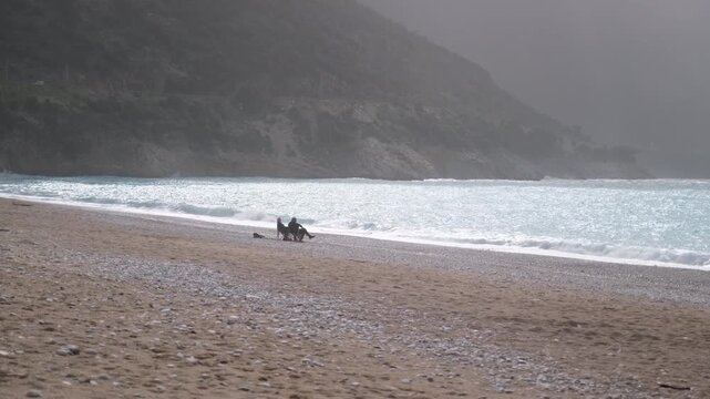 People sit on the beach, by the sea, at the Olu Deniz , Fethiye during the winter season.
