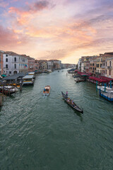 Fototapeta premium Venice Grand Canal with gondola and water taxi under pink sunset sky