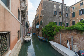 Moored boats on Venice water canal © Sergey
