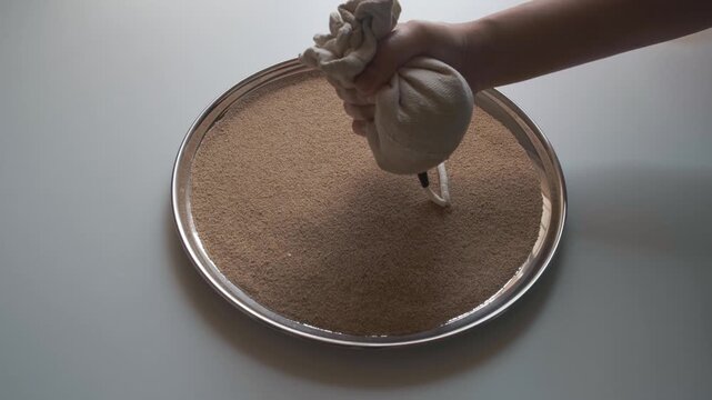 woman making fresh ornamental lentil dumplings. a popular Bengali food item in India 
