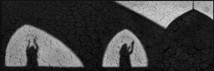 Iranian prayer. Creative black and white image with shadows on the cracked earth. Iran. Banner format. Concept photo. © delbars