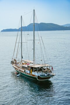 Wooden Gulet Sailing in Calm Sea with Mountains in Montenegro
