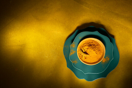 Turmeric spice in turquoise bowl 
