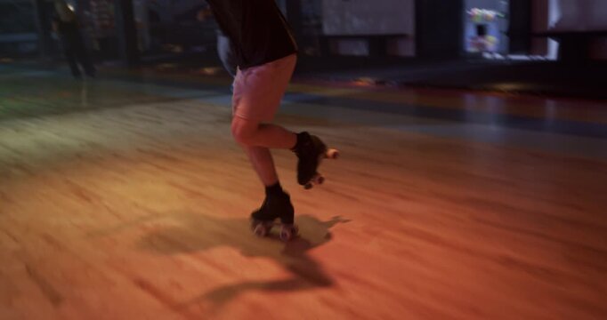 Epic roller skating moves of young man on disco floor with friends - steady cam movement