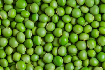 Fresh green pea seeds fill the background providing a seamless texture for healthy vegan food concepts and patterns