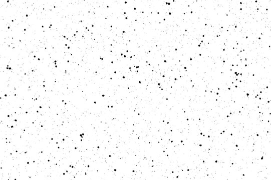 A striking pattern of numerous small black speckles scattered evenly across a bright white surface