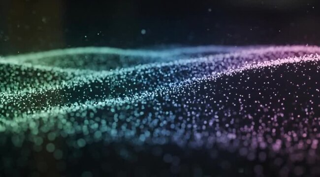 Abstract cinematic motion of glowing digital particles forming colorful green and purple waves on a dark background with shallow depth of field and bokeh light effects