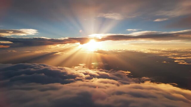 Aerial view of breathtaking sunrise above clouds, golden sun rays shining through, 4k video footage