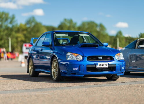 Gothenburg, Sweden - september 07 2025: Blue Subaru WRX STI sports car with gold wheels.