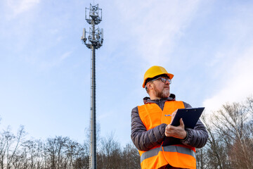 Engineer inspector inspecting 4G and 5G network equipment. Maintenance of cellular communication poles and maintains a telecommunications tower.