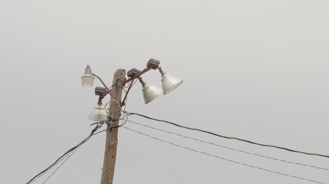 Sports field floodlights on wooden pole.