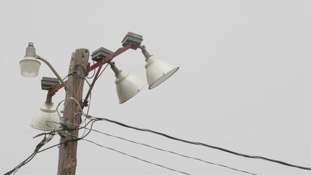 Sports field floodlights on wooden pole.