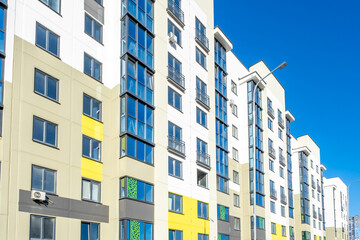 Modern Yellow and White Apartment Buildings in New Residential District Under Clear Blue Sky © Eugeniusz