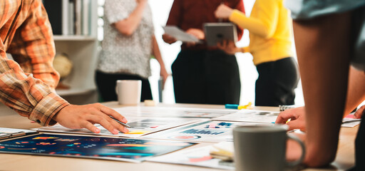 A dynamic workspace showcases a diverse team collaborating on creative projects, discussing...